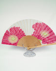 Silk fan with two pink African daisies on a white background. Exclusive piece of art to carry with you. Hand painted by Ottimare en stretched on a artisanal Spanish birch frame.