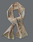 Long soft Tencel satin scarf by Ottimare with flower print for men and women in beige, yellow gold and yellow and light blue. Handmade in the Netherlands with a blind hem. This item is suitable for all seasons.