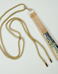 Beige lanyard attached to a silk fan out of the Ottimare collection.