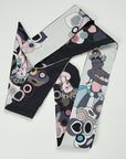 Beautiful deep black satin scarf designed and handmade by Ottimare in the Netherlands. The backside is n a soft grey tone. The ribbon shows four dansers with pink and blue accents.