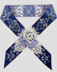 Twilly sjaaltje van Ottimare met jasmijn bloemen voor dames dat twee kanten heeft. Deze sjaal is donker blauw met paarsblauwe, witte en zandkleurige tinten. Handgemaakt in Nederland. One scarf, two sides.