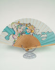 Silk fan displaying two sisters in bright pastels and aqua colours. Handpainted by Ottimare. Artisan production on birch wood.