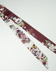 Pretty long ribbon scarf in bordeaux with an ivory white back. The beautiful details are in various colors green and blue. Handmade and designed by Ottimare in the Netherlands.