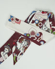 Elegant long ribbon scarf in bordeaux with an ivory white back. The beautiful details are in various colors green and blue. Handmade and designed by Ottimare in the Netherlands.