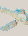 Small Ottimare ribbon scarf with fishing polar bears in sand, turquoise and light blue colours with salmon accents.