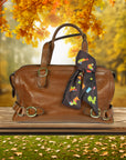Ottimare chocolate tangram scarf on a handbag on a wooden bench with autumn background. Dutch design, handmade in Netherlands
