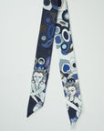 Smalle sjaal van Ottimare met Thangka danseres en danser in donker navy blauw met kobalt en paars. Dutch design en gemaakt in Nederland.
