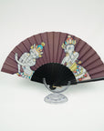 Silk fan with two Thangka dancers hand painted bij Ottimare on a taupe background with a black coated birch wood frame with gold colored ring.