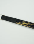 Silk fan in closed state hand painted by Ottimare with golden trumpet and black background on a birch wood panisch frame with a satin black coating and gold colored ring.