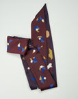 Extra long ribbon scarf in burgundy - bordeaux - on one side, and eggplant - aubergine color - on the other. Tangram figures in multi color blue, gold, camel, ivory. Ottimare