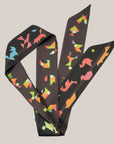 Tangram figures on a designer scarf from Ottimare.nl in chocolate, blue and green. De scarf has two different sides in two shades of chocolate brown