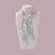 Floral patterned Ottimare scarf on a mannequin with Dutch design. Handmade from sustainable twill fabric.