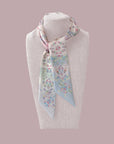 Floral patterned Ottimare scarf on a mannequin with Dutch design. Handmade from sustainable twill fabric.